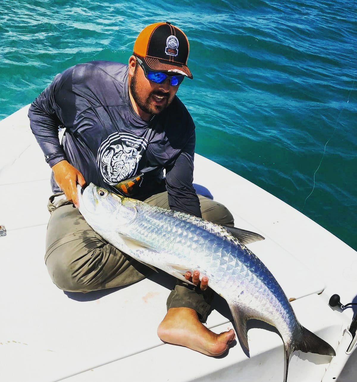 Man posing with a caught tarpon fish in Puerto Rico