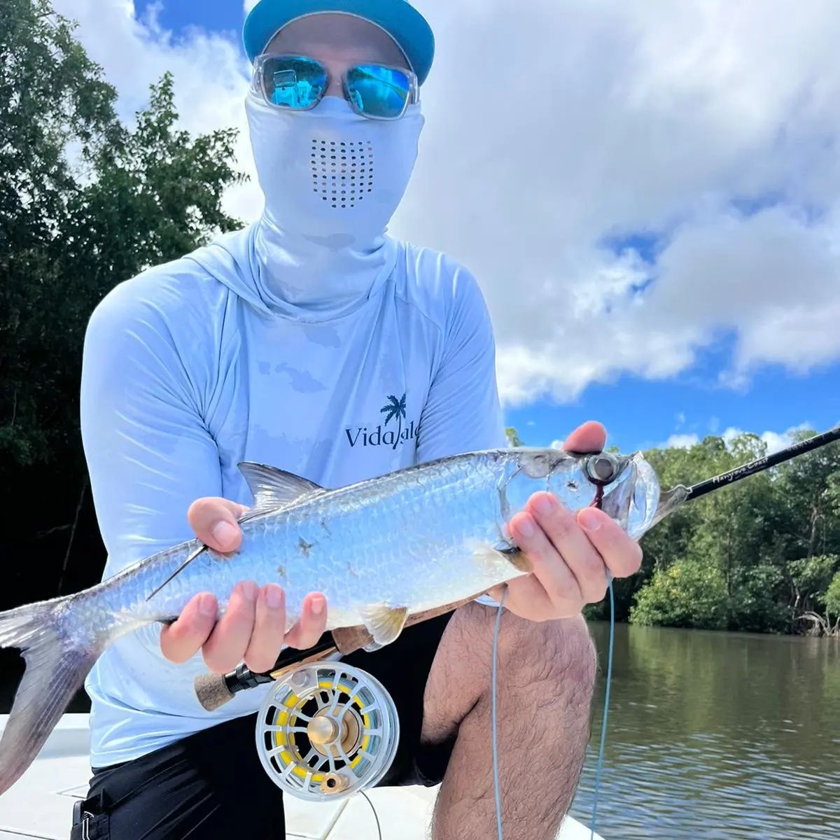 a person holding a fish in the water
