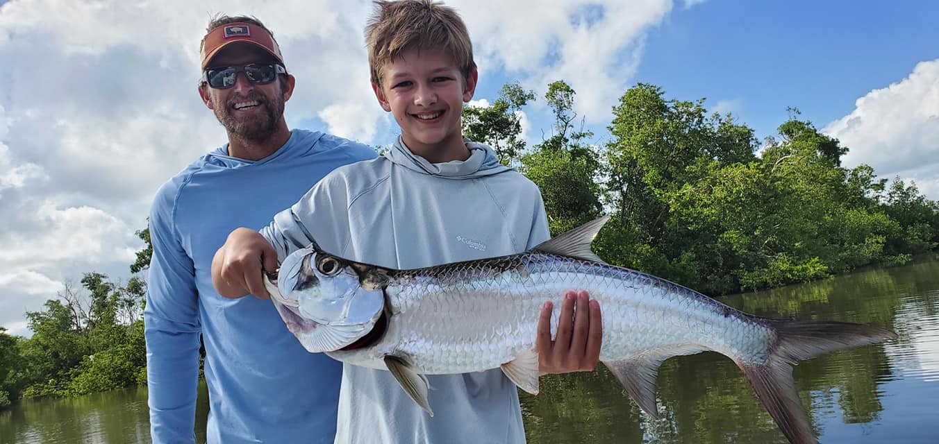 a man holding a fish swimming under water